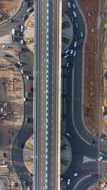 Aerial view of a bustling roundabout and flyover in Kaduna, Nigeria, showcasing urban transport infrastructure.